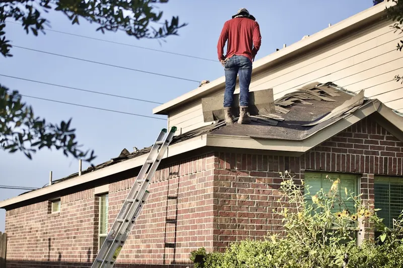 Professional roofer working on a residential roof in Friendship Station